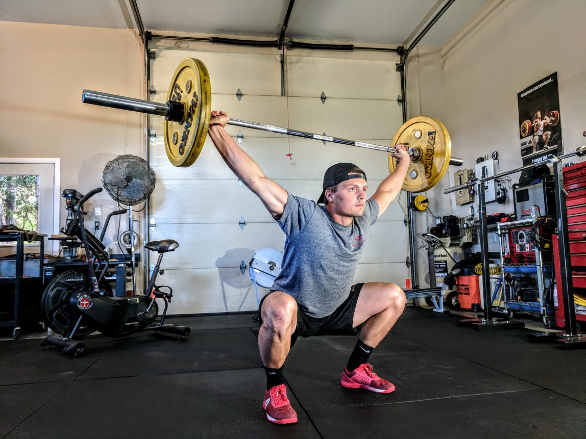 Training to prepare for an upcoming Heli Ski trip, photograph of weightlifting in the gym