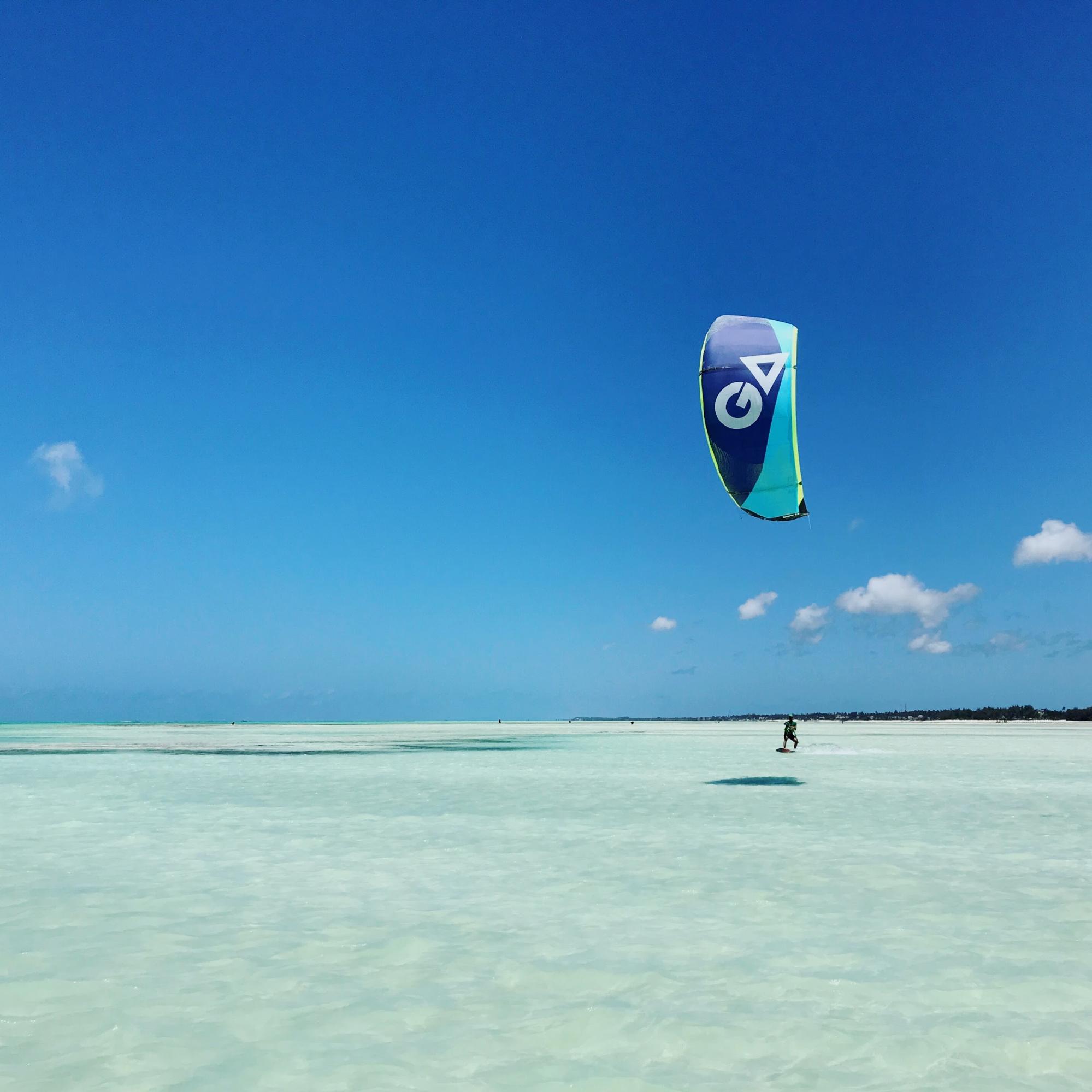 Cruising on a 12 meter kite across butter flat water directly in front of Zanzibar Kite Paradise