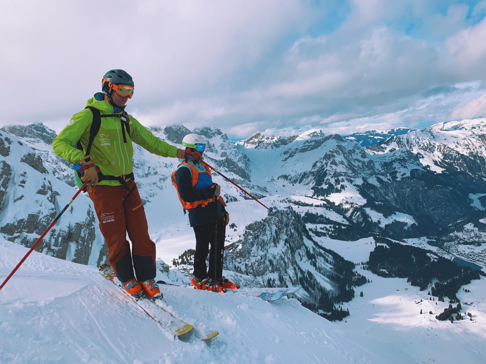 Galtiberg summit with two skiers looking down at their run